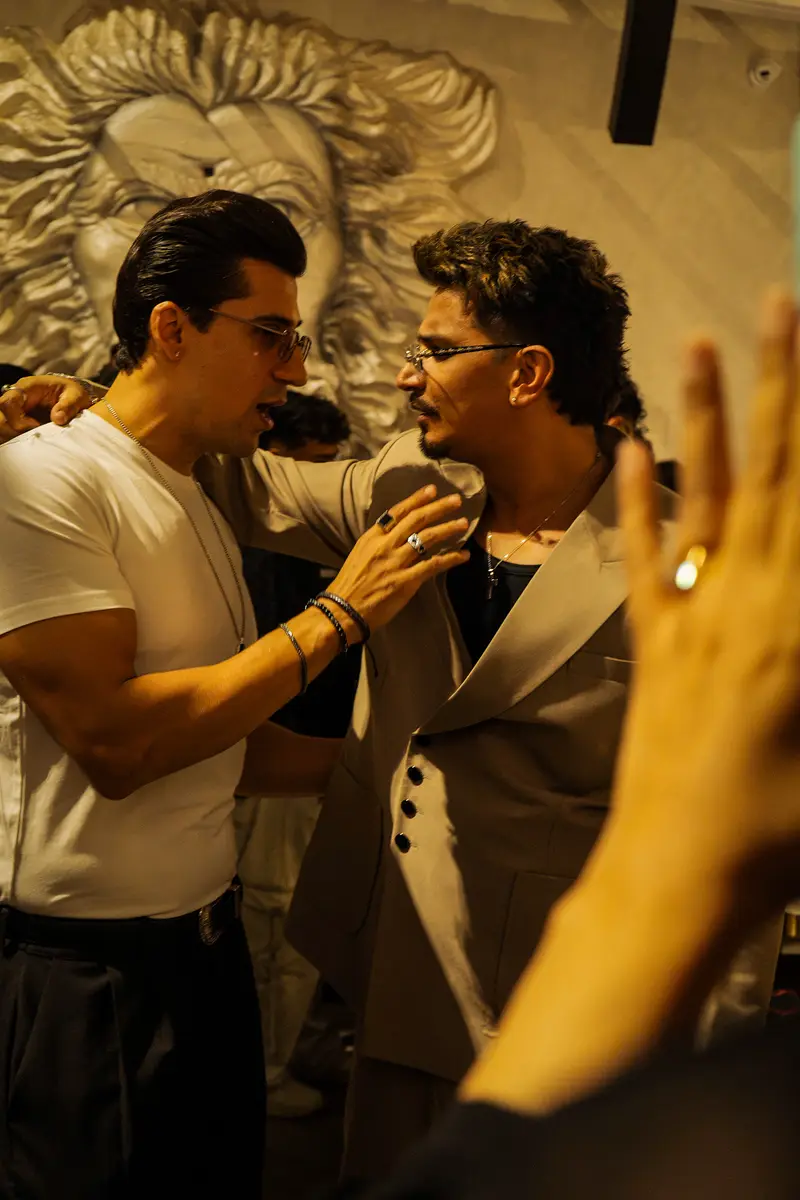 Friends raising a toast by the lion-face wall